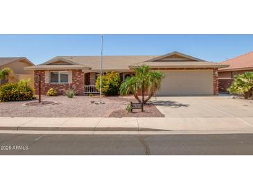 Charming single-story home with a well-manicured front yard and attached two-car garage at 7839 E Milagro Ave, Mesa, AZ 85209