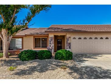 Charming single-story home with stone accents, desert landscaping and a two-car garage in a sunny neighborhood at 11360 E Keats Ave # 92, Mesa, AZ 85209