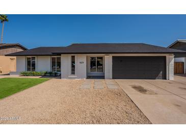 Newly renovated home with a modern desert landscape, fresh exterior paint, and a new roof at 1609 W Yukon Dr, Phoenix, AZ 85027