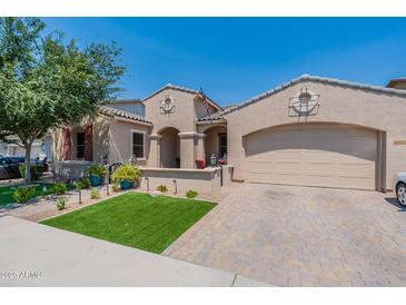 Charming single-story home with a two-car garage, landscaped front yard and welcoming front porch at 22851 S 229Th Pl, Queen Creek, AZ 85142