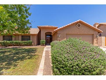 Charming single-story home showcasing manicured landscaping and a welcoming front entrance at 408 W Stacey Ln, Tempe, AZ 85284