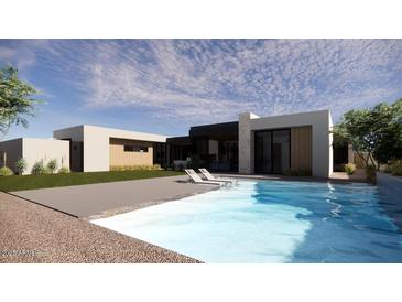 Inviting backyard pool with lounge chairs and a modern home exterior, perfect for relaxation and entertaining at 8528 E Clydesdale Trl, Scottsdale, AZ 85258