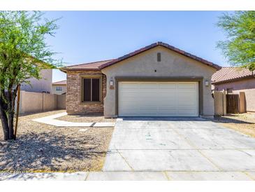 Charming single-story home featuring a two-car garage and stone veneer accents, creating an inviting curb appeal at 923 E Randy St, Avondale, AZ 85323