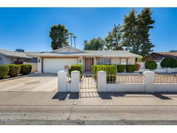 Charming single-story home featuring a well-maintained front yard and inviting curb appeal at 15608 N 57Th Dr, Glendale, AZ 85306