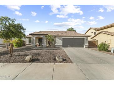 Charming single-story home with a two-car garage, neutral paint, and low-maintenance landscaping at 15969 W Adams St, Goodyear, AZ 85338