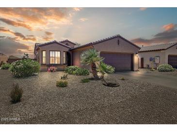 Charming single-story home features a two-car garage, desert landscaping, and tile roof at 16469 W Century Plant Dr, Surprise, AZ 85387