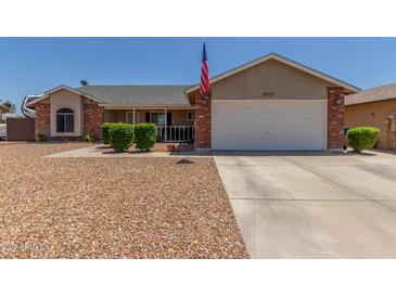 Charming single Gathering home featuring manicured landscaping and a two-car garage at 1925 W 12Th Ave, Apache Junction, AZ 85120