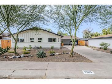 Charming white home with desert landscaping and mature trees provides curb appeal at 2109 W Berridge Ln, Phoenix, AZ 85015