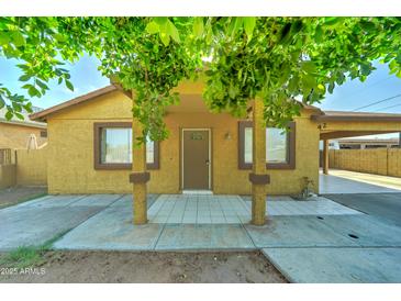 Charming single-story home with a covered porch and mature trees at 42 S Vineyard --, Mesa, AZ 85210