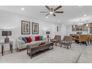 Bright living room featuring modern furnishings, a ceiling fan, and access to the dining area at 7777 E Main St # 215, Scottsdale, AZ 85251