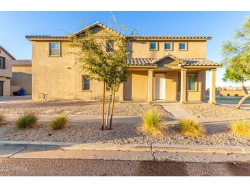 Charming two-story home featuring a welcoming front porch and low-maintenance desert landscaping at 840 E Agua Fria Ln, Avondale, AZ 85323