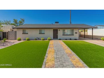 Charming single-story home featuring a well-manicured front yard with a paved walkway at 915 E Commonwealth Pl, Chandler, AZ 85225