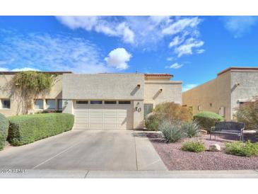Charming single-story home with a well-manicured front yard and a two-car garage at 943 E Kortsen Rd # 10, Casa Grande, AZ 85122