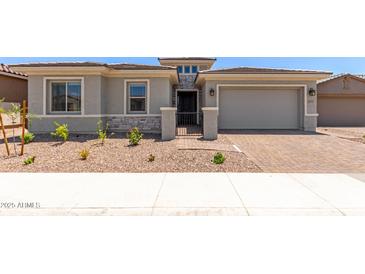 Charming single-Gathering home showcasing a two-car garage, landscaped yard, and a secure gated entrance at 11015 E Texas Ave, Mesa, AZ 85212