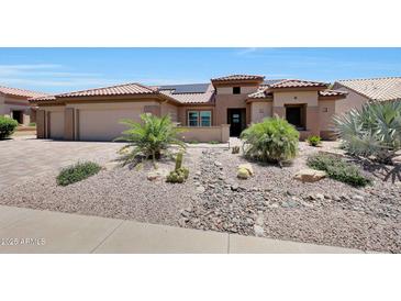 Inviting single-Gathering home featuring xeriscaping, desert plants, and a clay tile roof at 19745 N Mountain Sage Ln, Surprise, AZ 85374