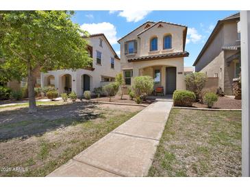 Inviting two-story home with a charming front yard and walkway at 3036 N Acacia Way, Buckeye, AZ 85396