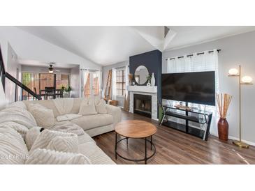Bright living room boasts vaulted ceilings, fireplace, modern decor, and an open floor plan for comfortable living at 4772 W Joshua Blvd, Chandler, AZ 85226