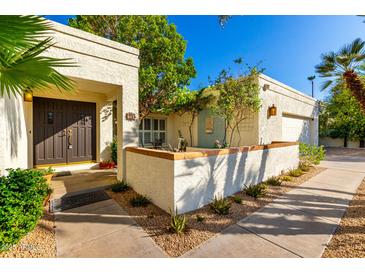 Well-maintained home featuring a charming front courtyard and desert landscaping at 507 W Sweetwater Ave, Phoenix, AZ 85029