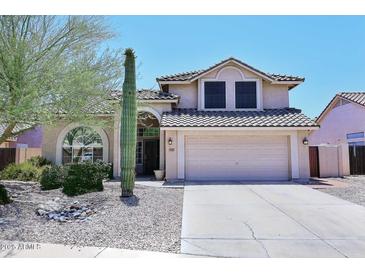 Charming two-story home featuring desert landscaping and a spacious two-car garage at 6023 E Scafell Cir, Mesa, AZ 85215