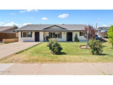 Charming single-story home boasting a well-maintained lawn and inviting curb appeal at 1050 W 9Th Pl, Mesa, AZ 85201