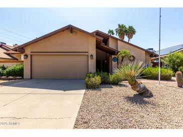 Charming single-story home with a two-car garage and desert landscaping at 18610 N 45Th Ave, Glendale, AZ 85308