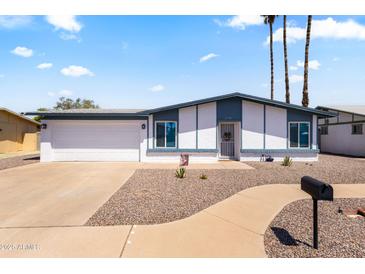 Charming single-story home with a well-manicured front yard and an attached two-car garage at 2706 W Isabella Ave, Mesa, AZ 85202