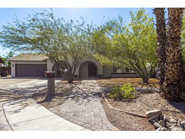 Charming single-Gathering home with mature trees, brick walkway, and lush landscaping at 3061 W Betty Elyse Ln, Phoenix, AZ 85053
