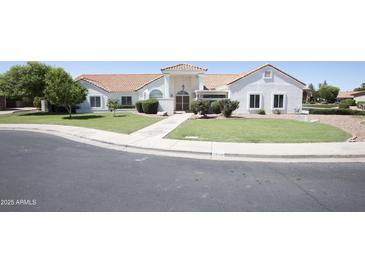 Charming single-story home boasts a well-maintained lawn and welcoming facade at 3314 E Draper Cir, Mesa, AZ 85213