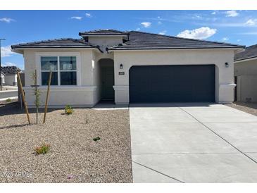 Charming single-story home featuring a two-car garage and desert landscaping for low maintenance at 469 W Freedom St, Florence, AZ 85132