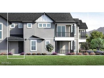 A view of the beautiful two-story home featuring a gray exterior, large windows, and a well-manicured lawn at 11300 N Casa Dega Dr # 1082, Surprise, AZ 85388