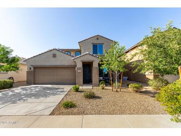 Two-story stucco home featuring a two-car garage, low maintenance landscaping, and covered entryway at 17946 W Via Del Sol --, Surprise, AZ 85387