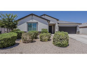 Charming single-story home featuring desert landscaping and a two-car garage at 18766 N Salerno Dr, Maricopa, AZ 85138