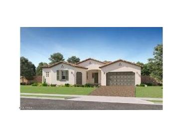 Beautiful single-story home with a well manicured lawn, desert landscaping, and a two car garage at 23098 E Nightingale Rd, Queen Creek, AZ 85142