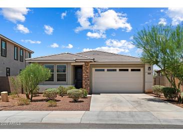 Charming single-story home with desert landscaping, tile roof and a two-car garage at 2410 S 124Th Dr, Avondale, AZ 85323