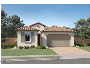 Beautiful single-story home with a tile roof, manicured lawn, and a two-car garage at 4999 S 233Rd Dr, Buckeye, AZ 85326