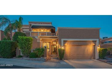 Charming two-story home with attached two car garage, desert landscaping and a cozy balcony at 11025 N 10Th St, Phoenix, AZ 85020