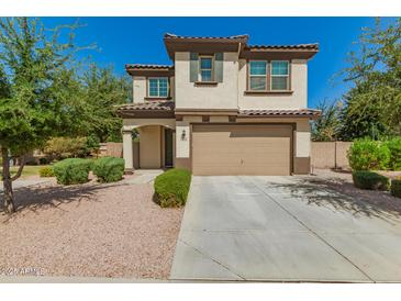 Charming two-story home with a well-manicured front yard and a two-car garage at 263 N Wilson Dr, Chandler, AZ 85225