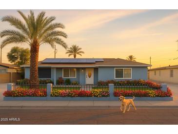 Charming single story home with desert landscaping, solar panels, and a friendly dog at 2718 W Montebello Ave, Phoenix, AZ 85017