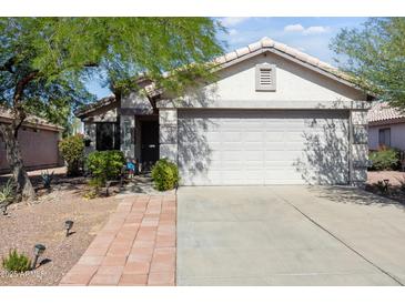 Charming single-story home featuring a two-car garage, desert landscaping, and a cozy covered entrance at 3534 N 106Th Ln, Avondale, AZ 85392