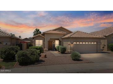 Charming single-story home with a tile roof, mature landscaping, and a welcoming front entrance at 4459 E Desert Wind Dr, Phoenix, AZ 85044