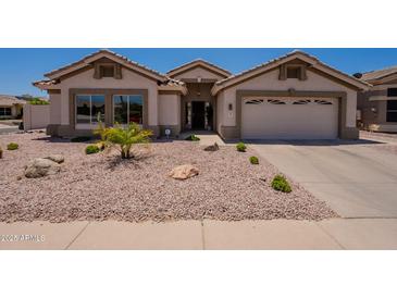 Inviting single-story home featuring a low-maintenance desert landscape and a two-car garage at 509 W Villa Rita Dr, Phoenix, AZ 85023