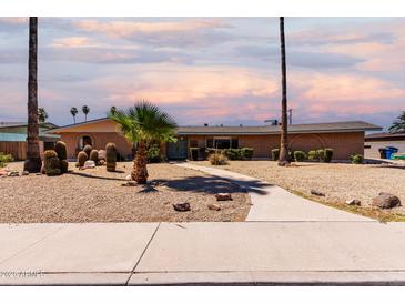Charming single-story home featuring desert landscaping, a walkway, and a classic brick facade under a colorful sky at 533 E 7Th Pl, Mesa, AZ 85203