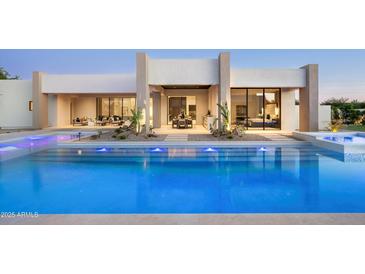 Inviting pool featuring lights and a modern design, seamlessly blending indoor and outdoor living spaces at 6702 E Cholla St, Scottsdale, AZ 85254