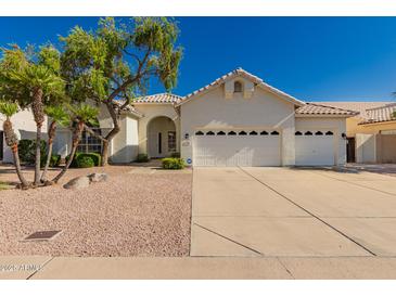 Beautiful single-story home with a three-car garage and mature landscaping in a well-maintained neighborhood at 1213 W Beck Ln, Phoenix, AZ 85023