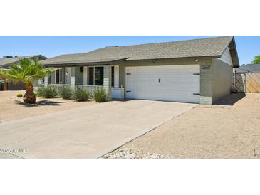 Charming single-story home with a well-maintained front yard and a two-car garage at 13842 N 40Th Ave, Phoenix, AZ 85053