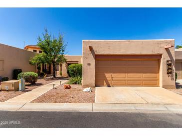 Charming single-story home featuring desert landscaping and a two-car garage in a peaceful residential neighborhood at 14428 W Moccasin Trl, Surprise, AZ 85374