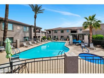 Resort-style pool area with lounge chairs, hot tub, pergola, and beautiful landscaping for relaxation at 14815 N Fountain Hills Blvd # 201, Fountain Hills, AZ 85268