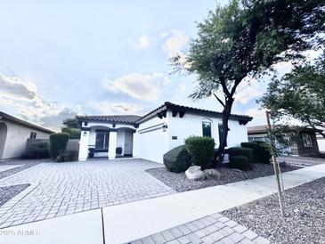 Charming single-story home with a well-manicured front yard and paved driveway at 1812 S Racine Ln, Gilbert, AZ 85295