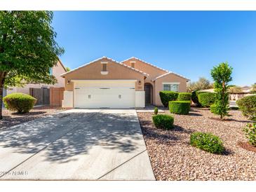 Charming single-story home featuring a well-manicured front yard and a two-car garage at 2053 E Saddlebrook Ct, Gilbert, AZ 85298
