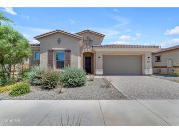 Charming single-story home with desert landscaping, a paver driveway, and a two-car garage at 22788 E Orion Way, Queen Creek, AZ 85142